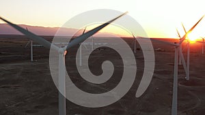 Wind Turbines at Sunset. Windenergy farm with many turbine windwill generating alternative energy. Windy park