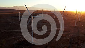 Wind Turbines at Sunset. Windenergy farm with many turbine windwill generating alternative energy. Windy park