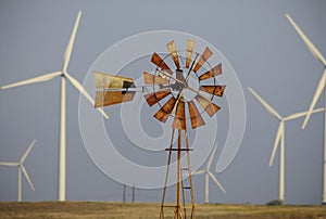 Wind turbines surround windmill