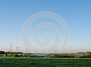 wind turbines under blue sky in german saarland in spring