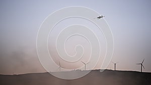 Wind turbines, wildfire and airplane