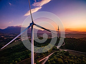Wind Turbines Windmill Energy Farm at sunset in Italy