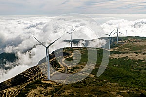 Wind Turbines, Windmill Generators farm over the clouds.