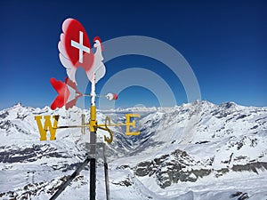 Wind vane weathercock in front of Matter Valley in Zermatt ski region, Switzerland photo