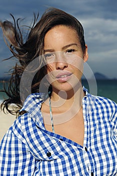 Wind: woman with tousled hair at the sea photo