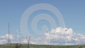 Windfarm contributing to renewable power, Wind turbines rotating to generate green electricity, stainable wind turbine technology