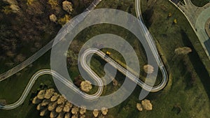 A winding bike path in a city park. Flight over the spring city park. Aerial photography