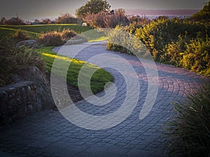 Winding cobblestone path at sunset