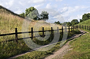 Winding Country Road With Wooden Fence