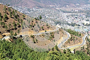 Winding or curved asphalt road on the hill with view of Thimphu