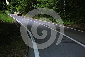 Winding dangerous forest asphalt road with markings