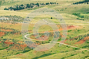 A winding dirt road on the eastern edge of the Bighorn National Forest in Wyoming, USA