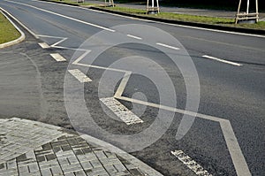 junction. parking at these places is prohibited. concrete curbs and paving trees and lawn photo