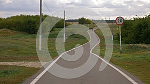 Winding long path way at country landscape.