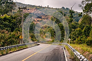 Winding mountain asphalt road through the forest.