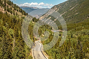 Winding Mountain Highway with Motorbike Rider in Distance