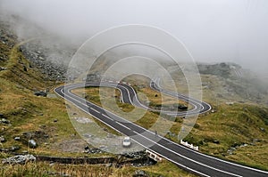 Winding mountain road Transfagarasan and fog in Romania