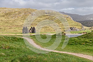 Winding path leading to the hauntingly beautiful ruins of Calda House in the Scottish Highlands