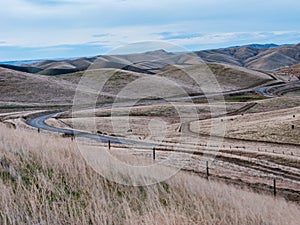 Winding Paved and Dirt Roads on Rolling Hills