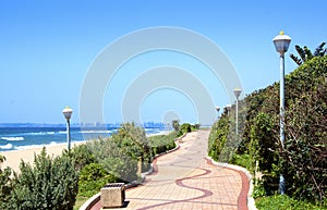 Winding Pedestrian Walkway With Beach And Ocean Backdrop