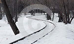 The winding railway. Snowy railroad tracks