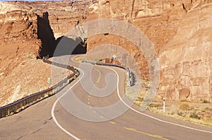 A winding road curves through red rock in the desert southwest USA