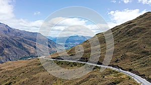 Winding road high in the mountains between Queenstown and Wanaka, called Crown Range