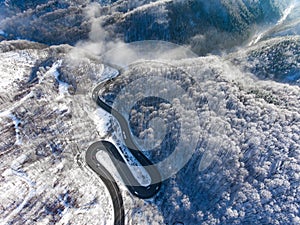 Winding road in the middle of the winter in a high mountain pass