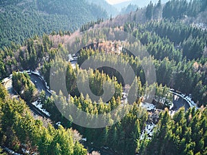 Winding road in the mountains with a car passing through