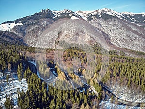 Winding road in the mountains with a car passing through