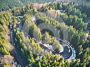 Winding road in the mountains with cars passing through