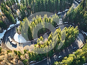 Winding road in the mountains with cars passing through