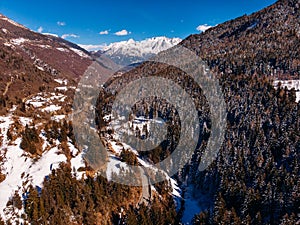 Winding road in mountains of Italy Alps. Sunny day. Aerial top view