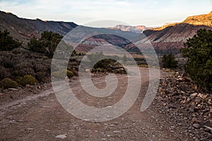 Winding road in shadow at sunset through the desert of Southern