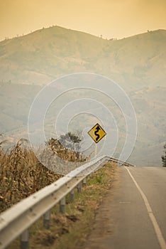 Winding Road Sign on asphalt road