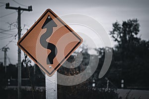 Winding road signage warning of dangerous coast road curves ahead