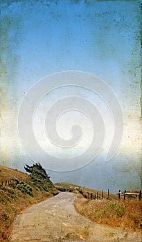 Winding Road to the Sea on Grunge background