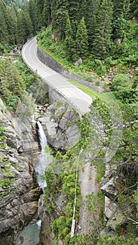 Winding road and waterfall in Guttannen