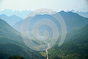 Winding roads through valleys and karst mountain scenery in the North Vietnamese region of Ha Giang / Van