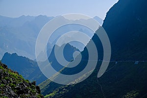 Winding roads through valleys and karst mountain scenery in the North Vietnamese region of Ha Giang / Van