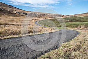 Winding tar roa in dry grasslands