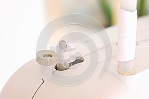 Winding threads on a bobbin on sewing machine.