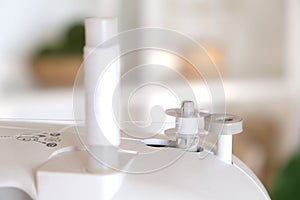 Winding threads on a bobbin on sewing machine.