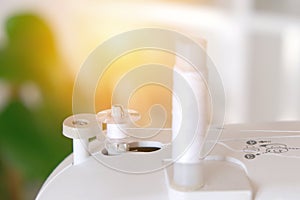 Winding threads on a bobbin on sewing machine.