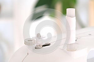 Winding threads on a bobbin on sewing machine.