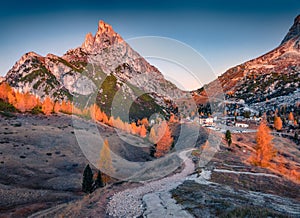 Winding trek to Falzarego pass with Forcella and Sass de Stria peaks on background photo