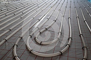 Winding tubes of the hydronic radiant heating system on the floor