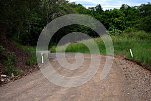 Winding unsealed rural road landscape