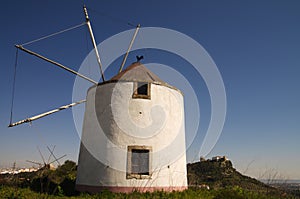 Windmill against Palmela castle photo