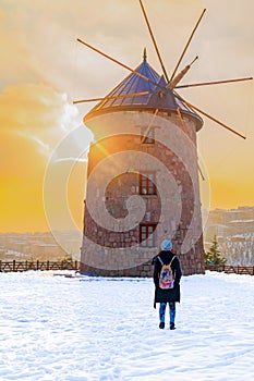 Windmill in Altinkoy in the sunset with rear view of a girl, Ankara/Turkey